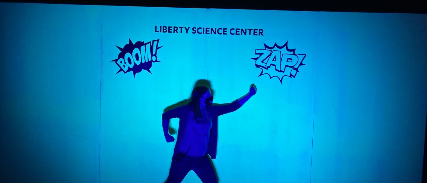 Making superhero poses at the Shadow Wall