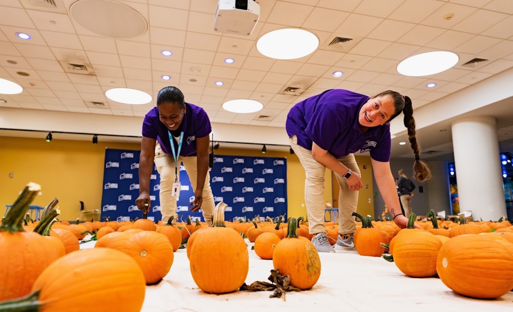 LSC staff setting up indoor pumpkin patch