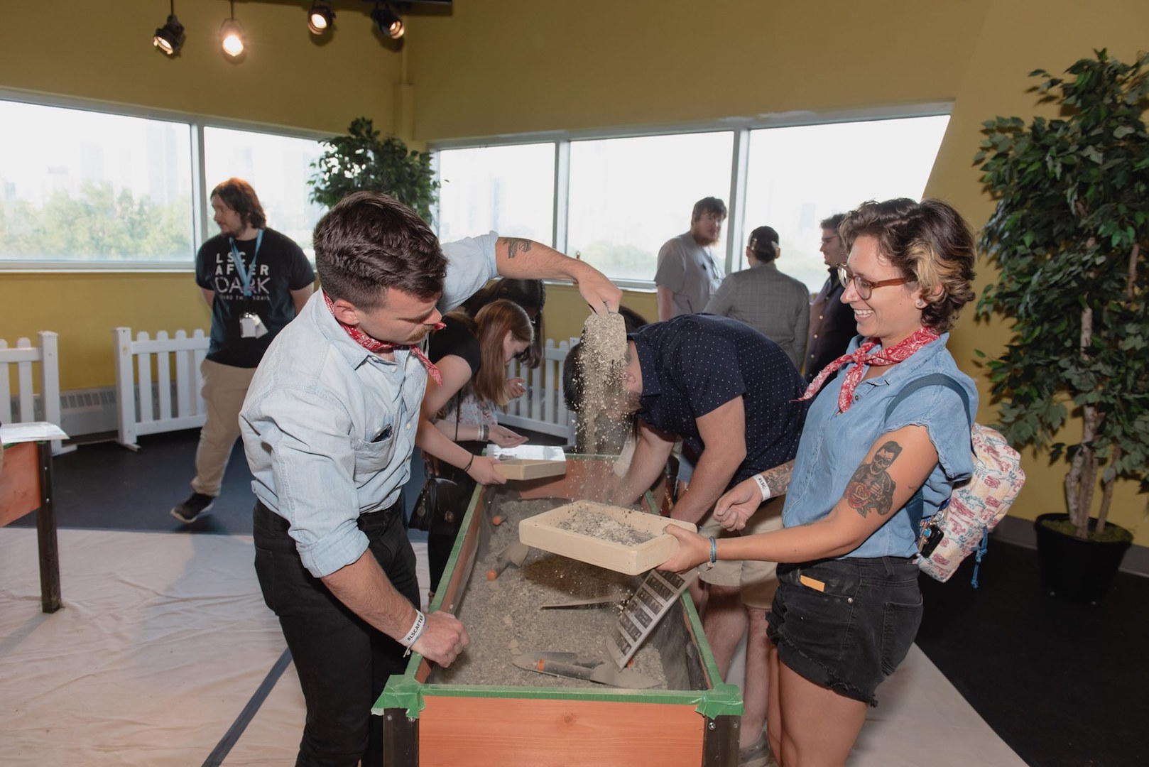 Guests look through gravel to find tiny fossils