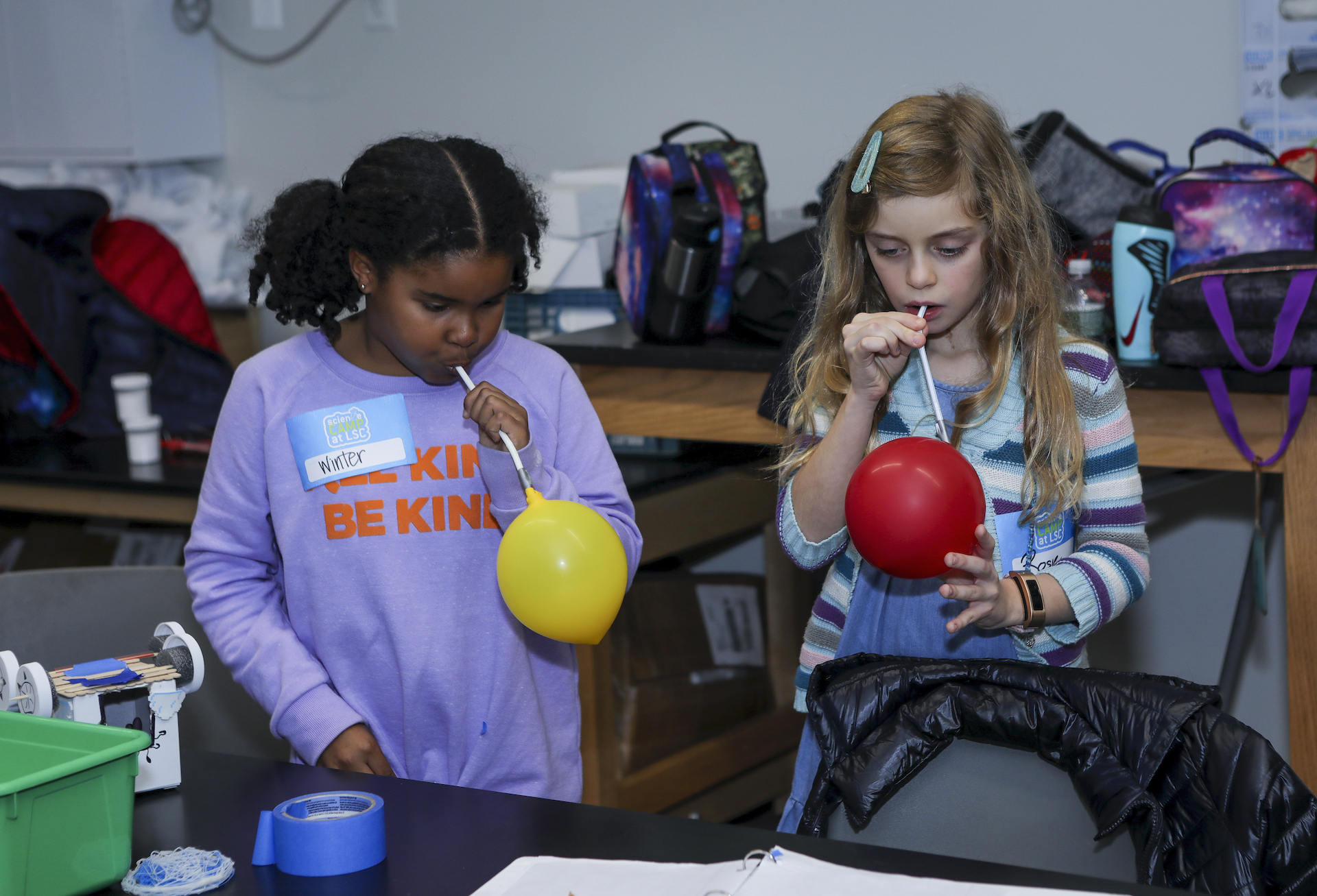 Kids blowing up balloons to use for Angry Birds transportation device