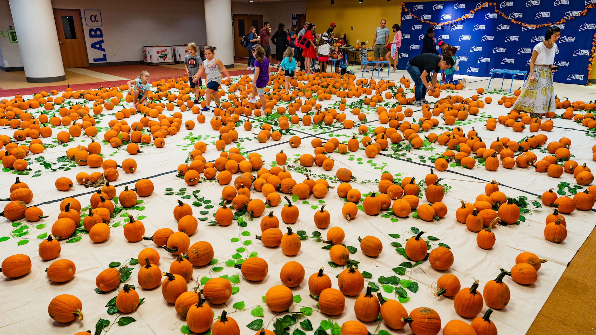 Kids exploring indoor pumpkin patch