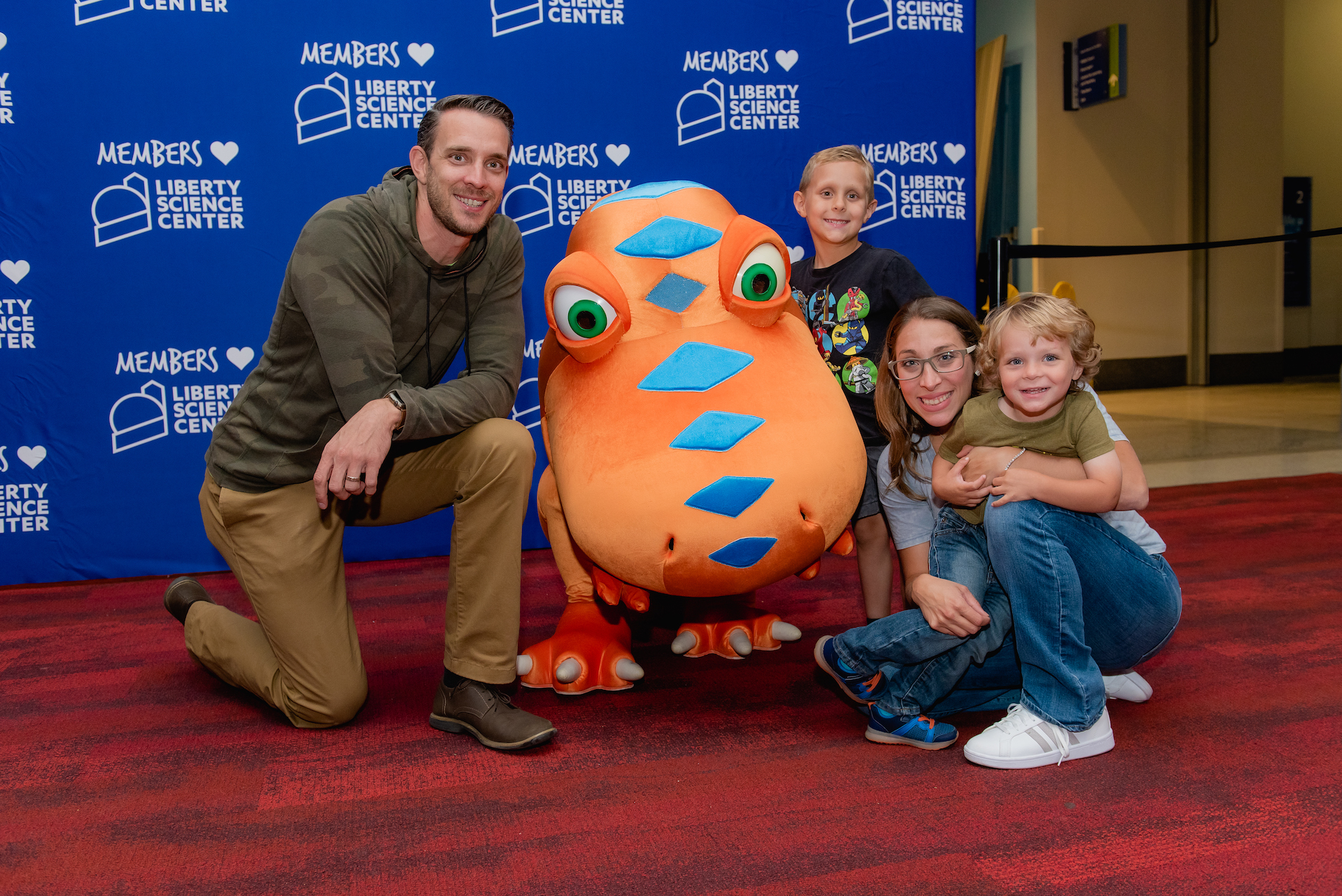 Family with Buddy the T-Rex costume character