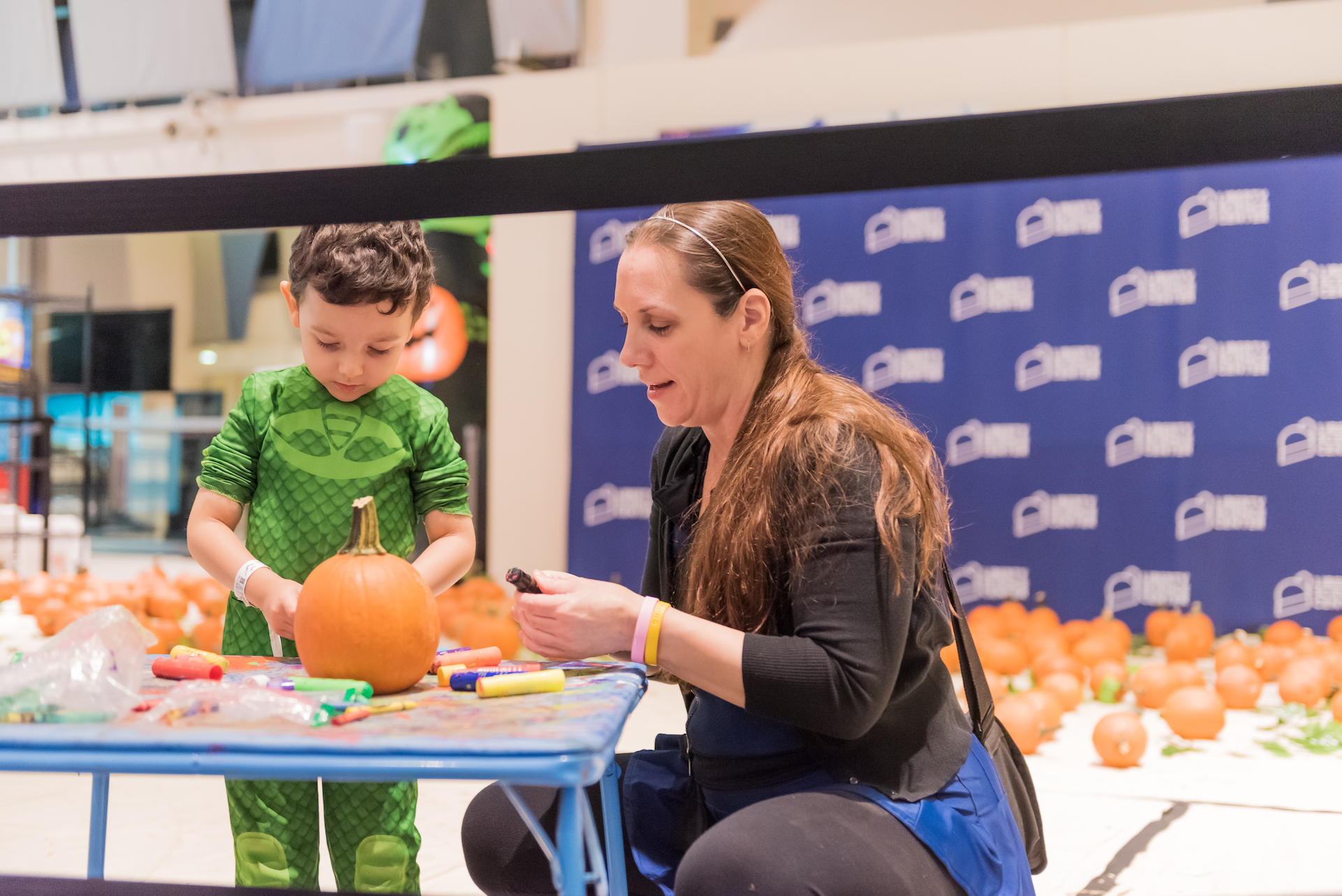 Guests painting pumpkins