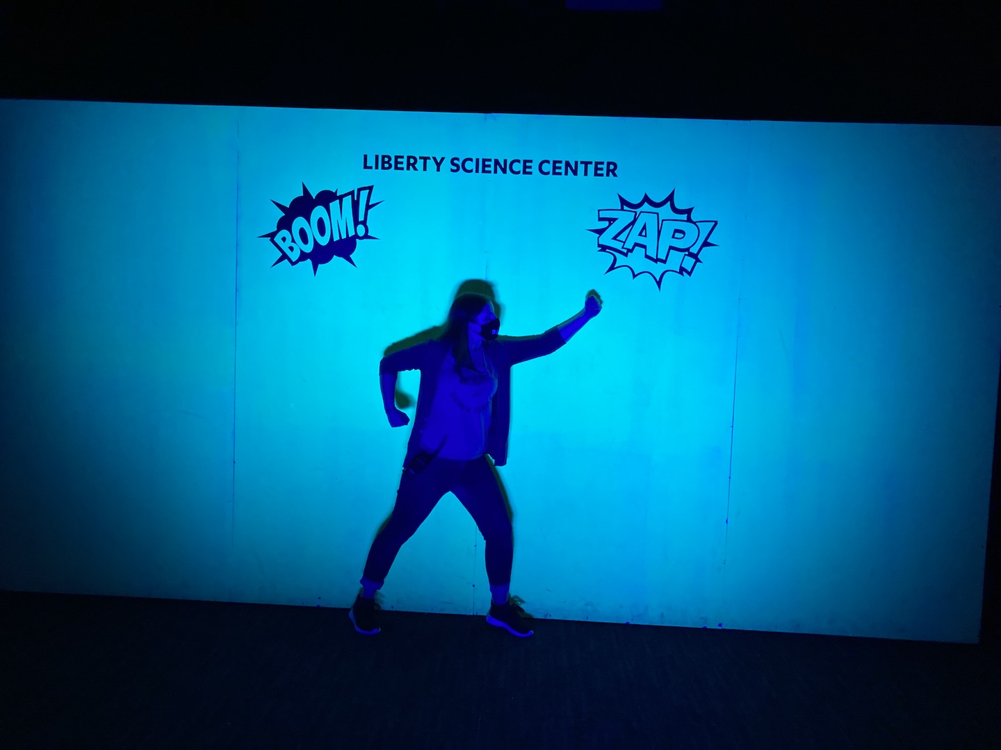 Making superhero poses at the Shadow Wall