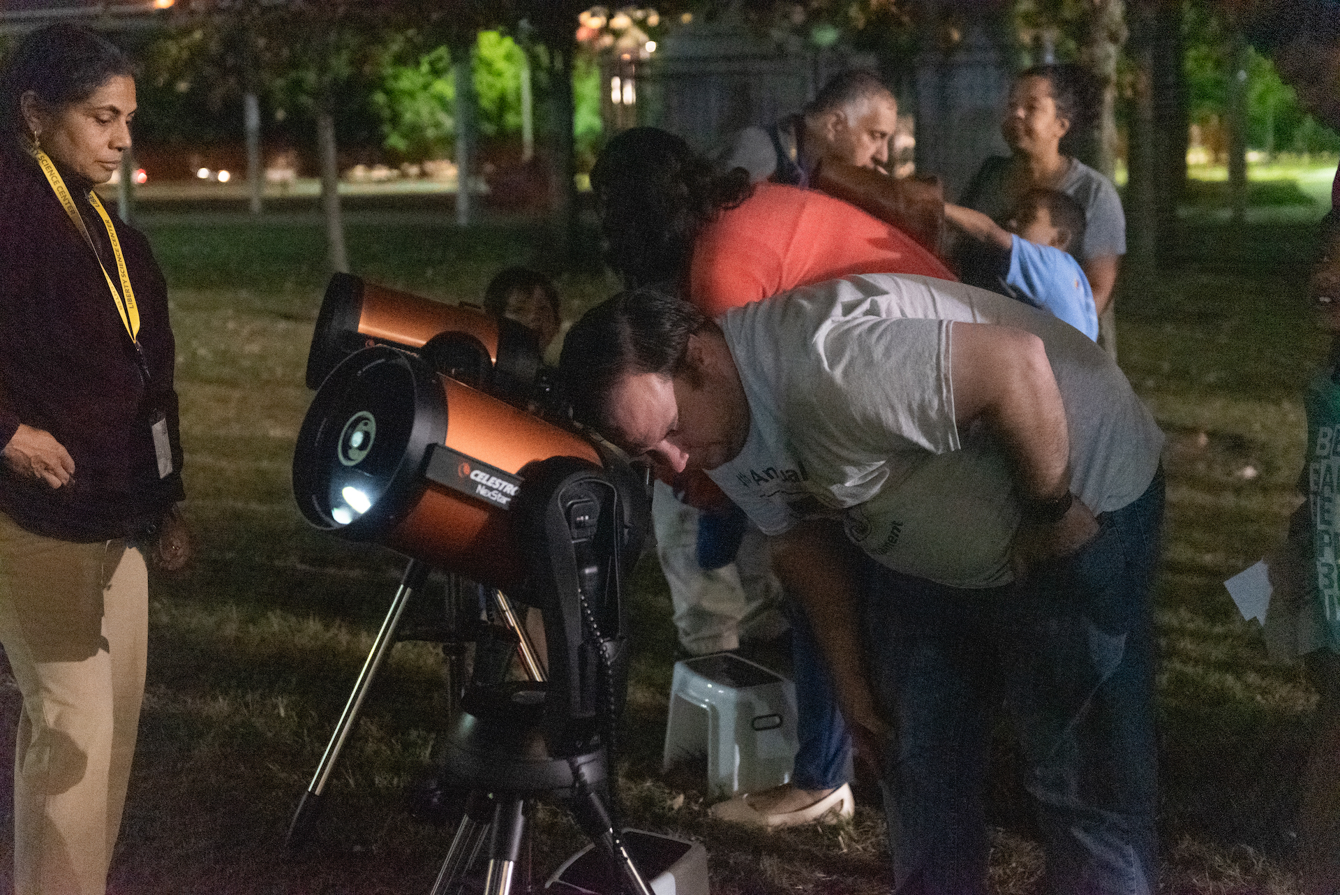 Man looking through telescope