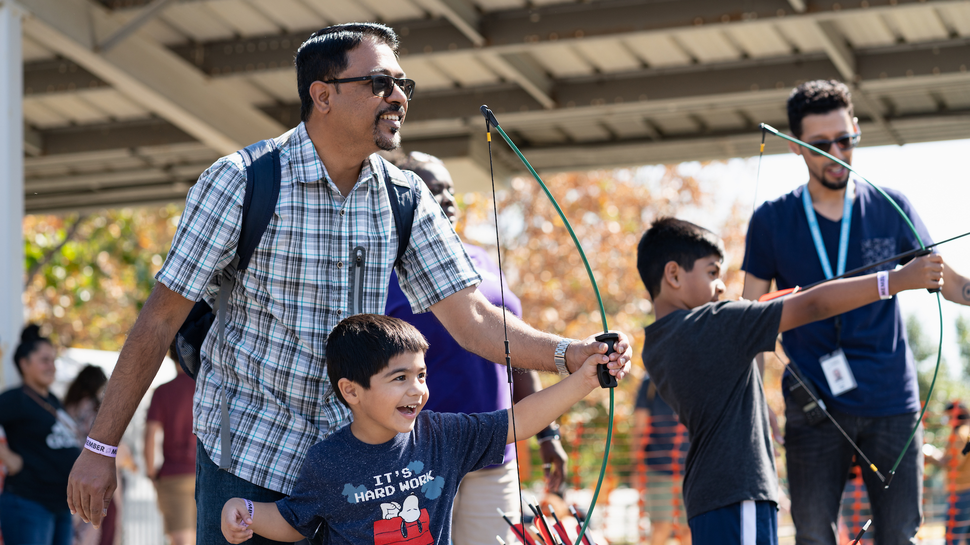 Man and boy using bow and arrow at Ballistic Apple Picking activity