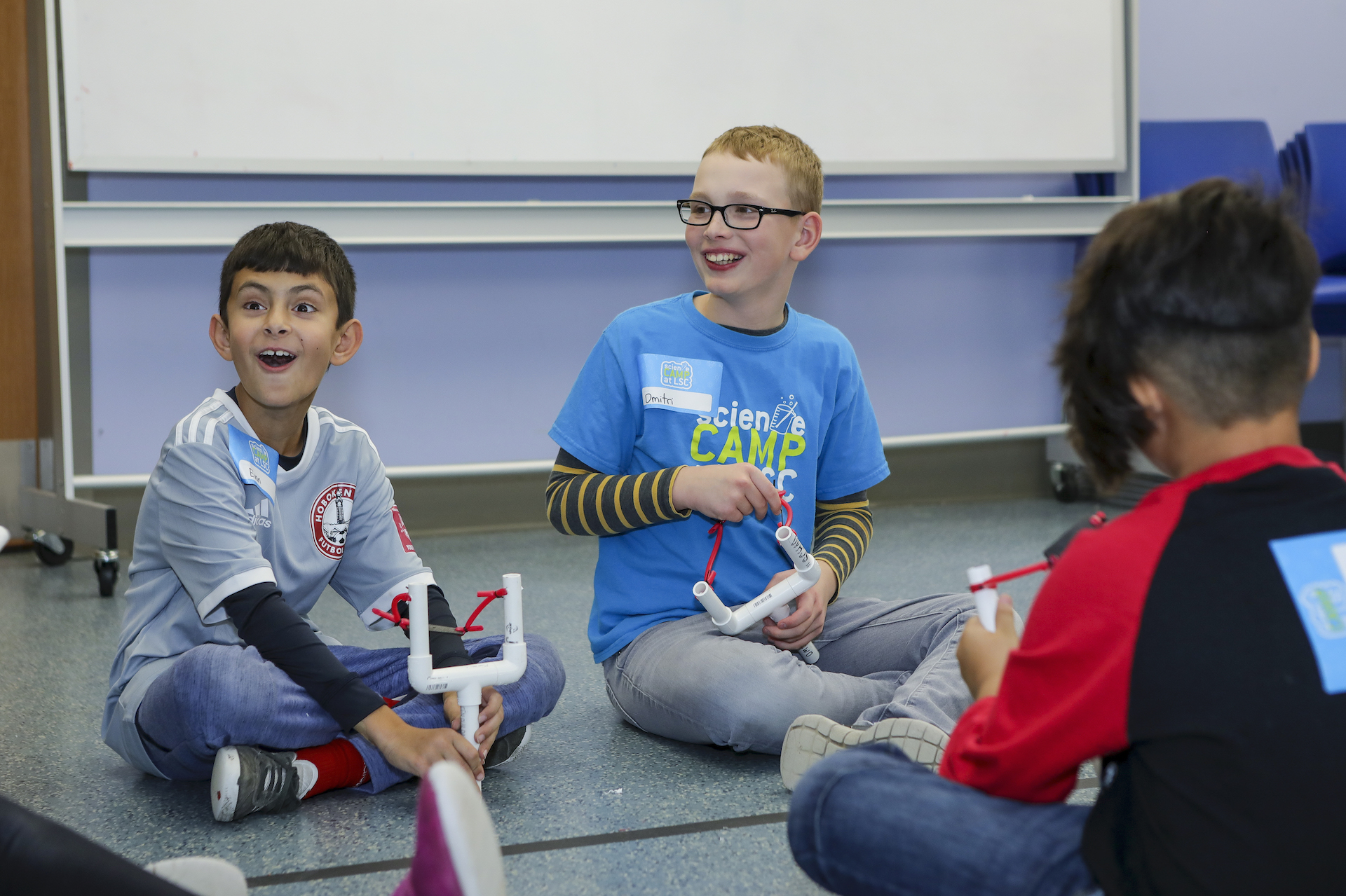 Kids testing slingshots